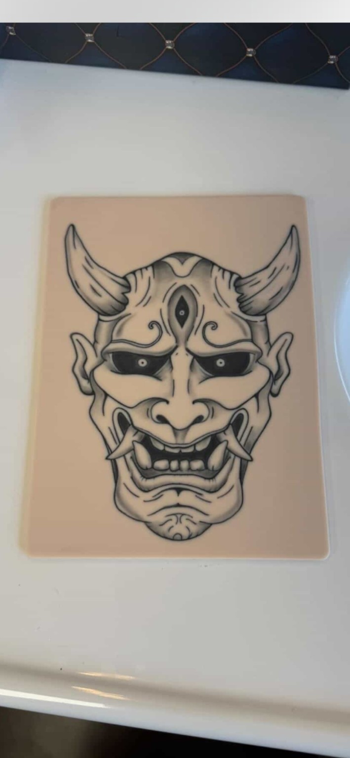 Original photograph: tattoo artist Hannya mask artwork on a Practice Skin Co. sheet